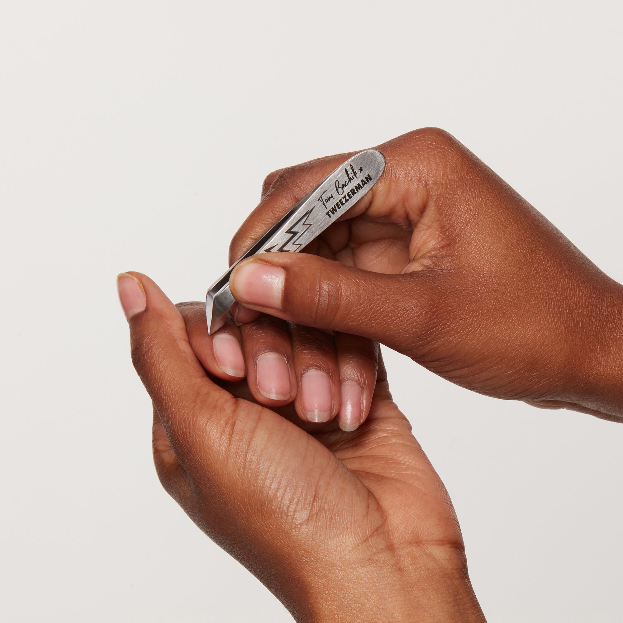 Model using Tom Bachik x Tweezerman mini cuticle nipper